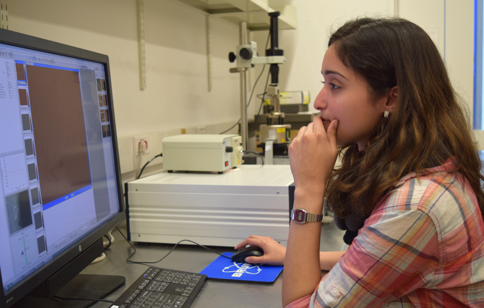 student working at a computer in a nanoscience lab