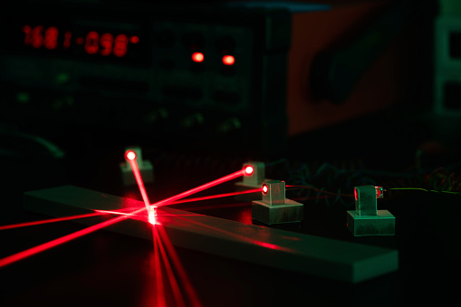 photo of red-color lasers converging