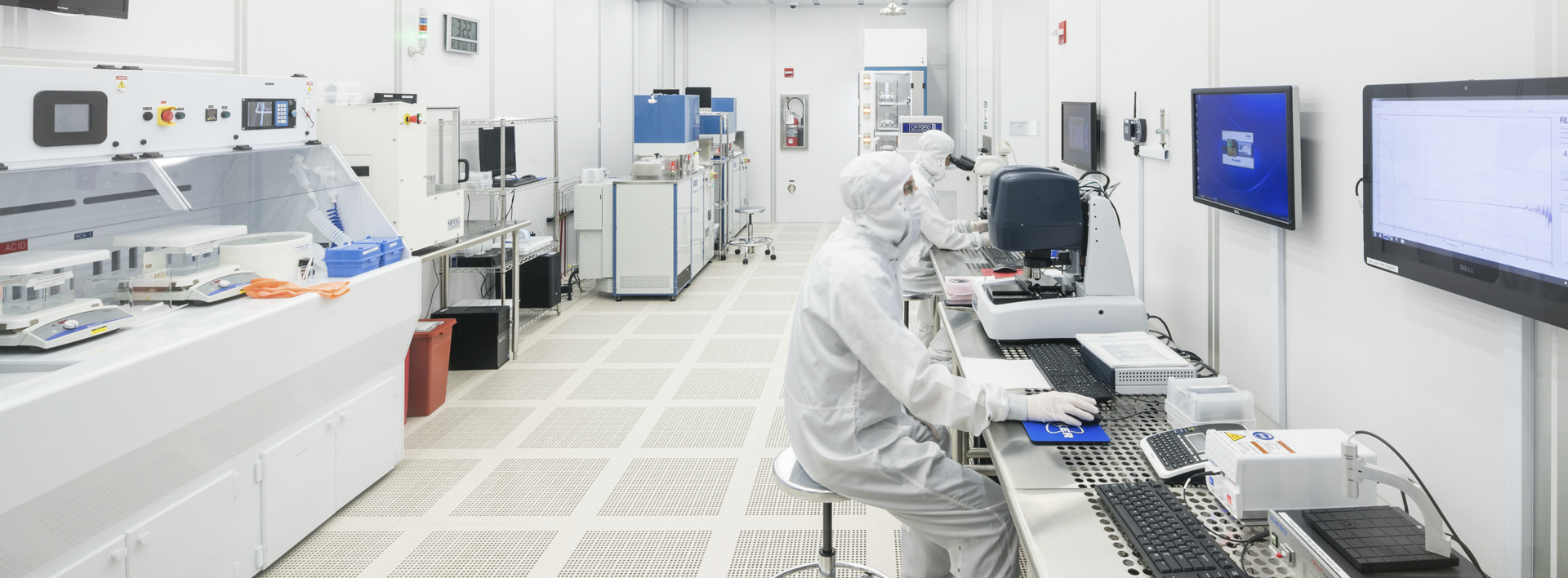 researcher in a nanoscience lab wearing cleanroom gear