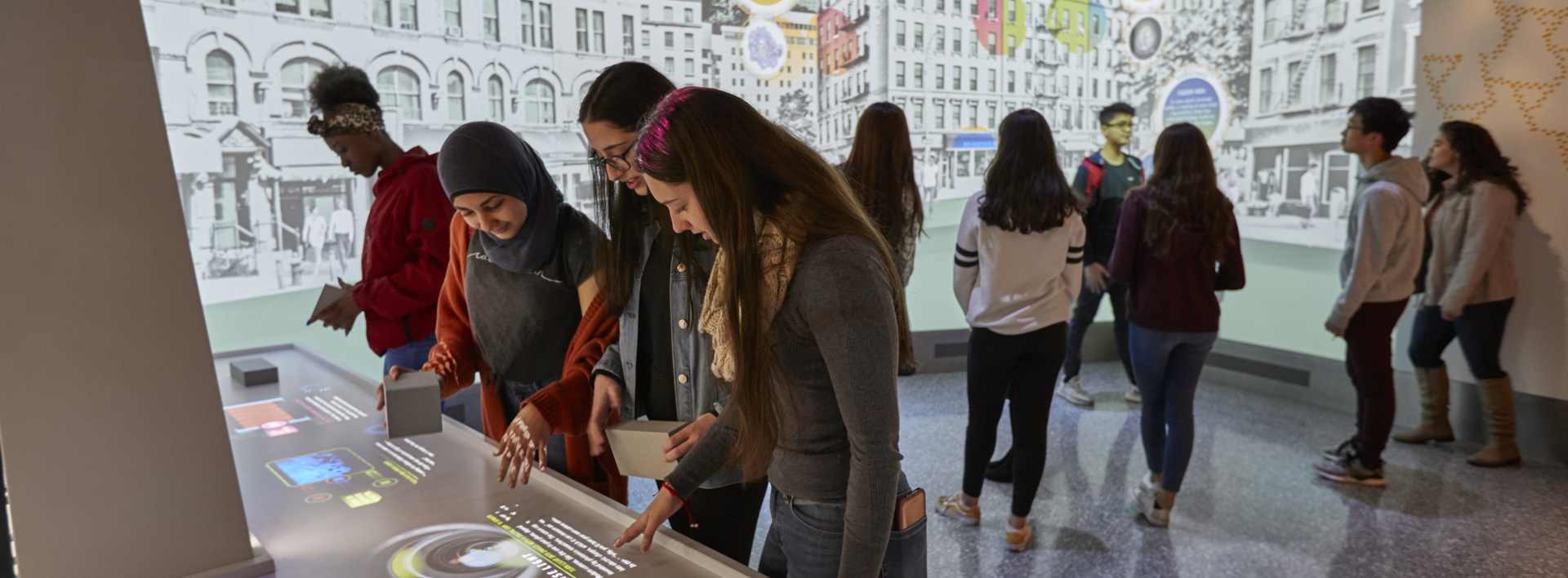 students interacting with exhibits in the ASRC Illumination Space