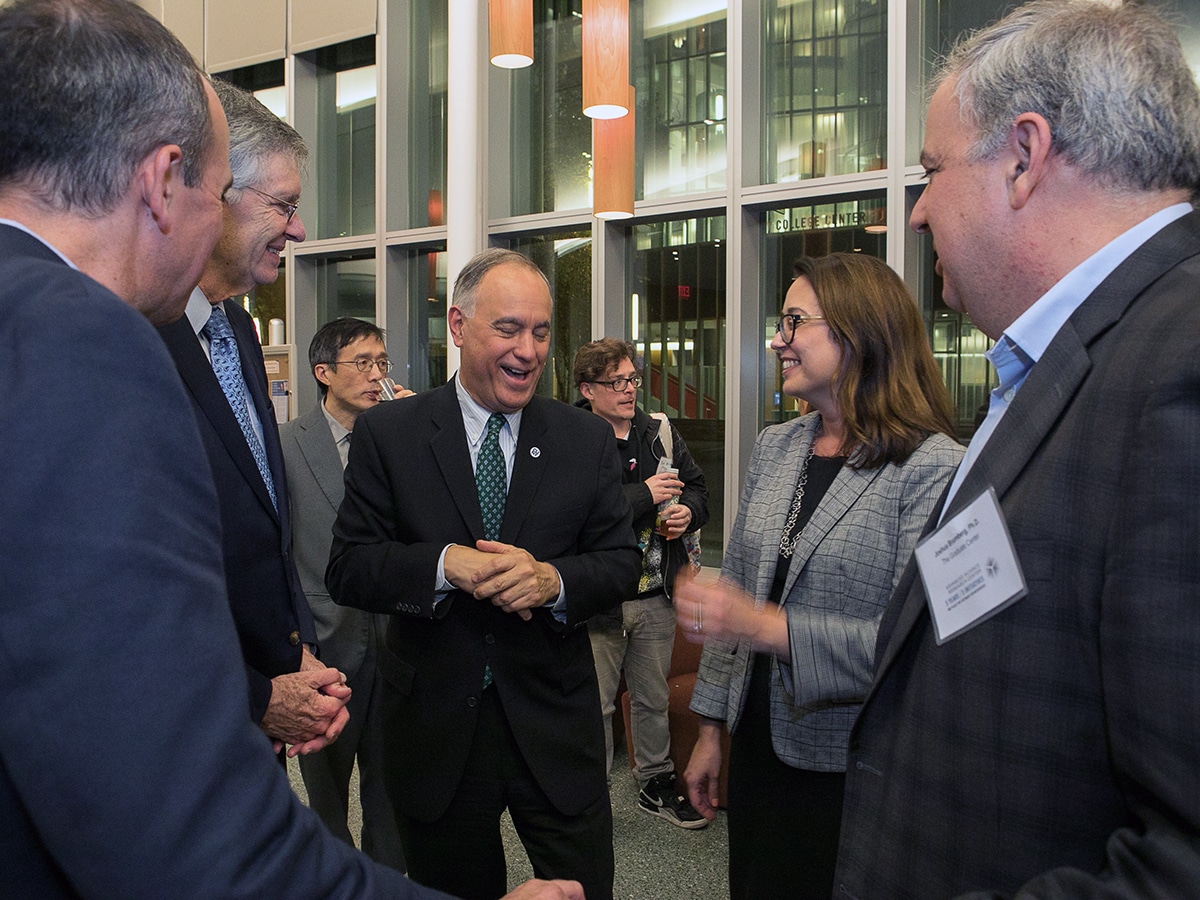 ASRC leadership speaking in a group at the anniversary reception