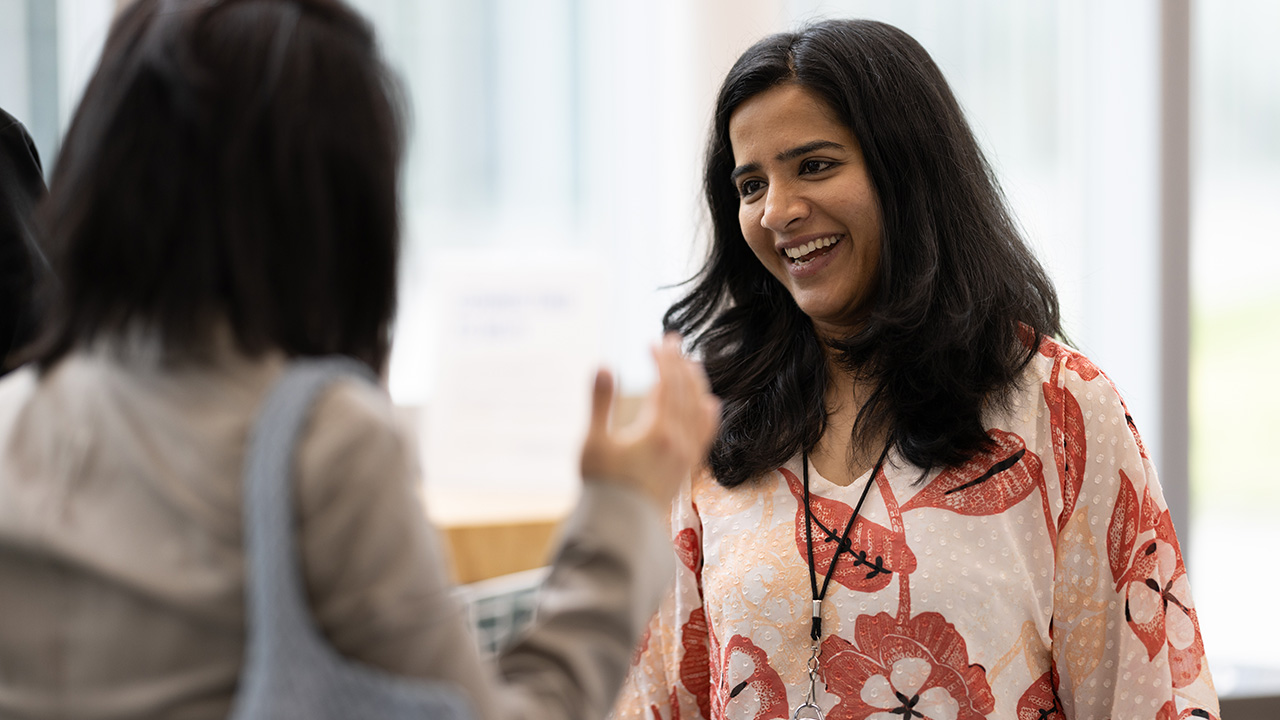 A woman smiling while talking to someone