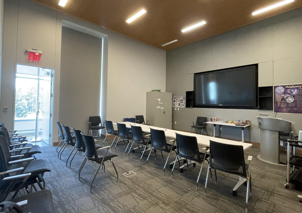 the same seminar room setup, pictured from the far side of the room looking toward the doorway