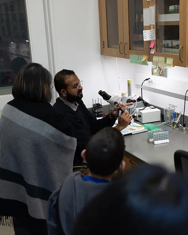 A scientist showing guests research in his lab