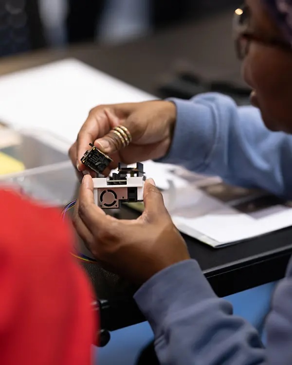 A person building an air quality sensor