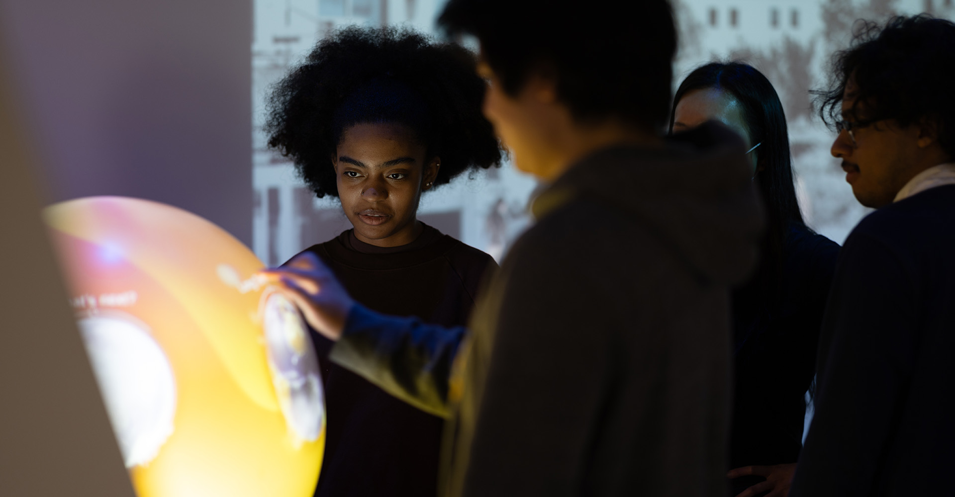 Young people interacting with an exhibit at the CUNY ASRC IlluminationSpace