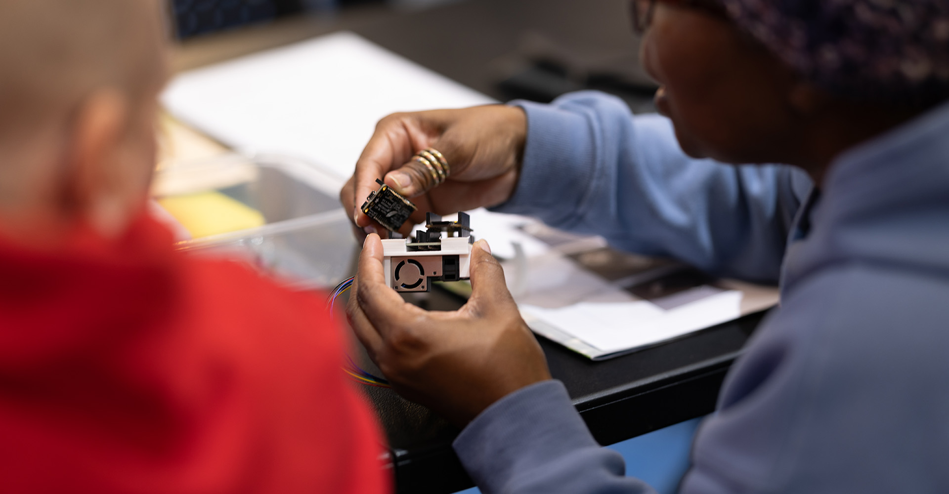 A person building an air quality sensor