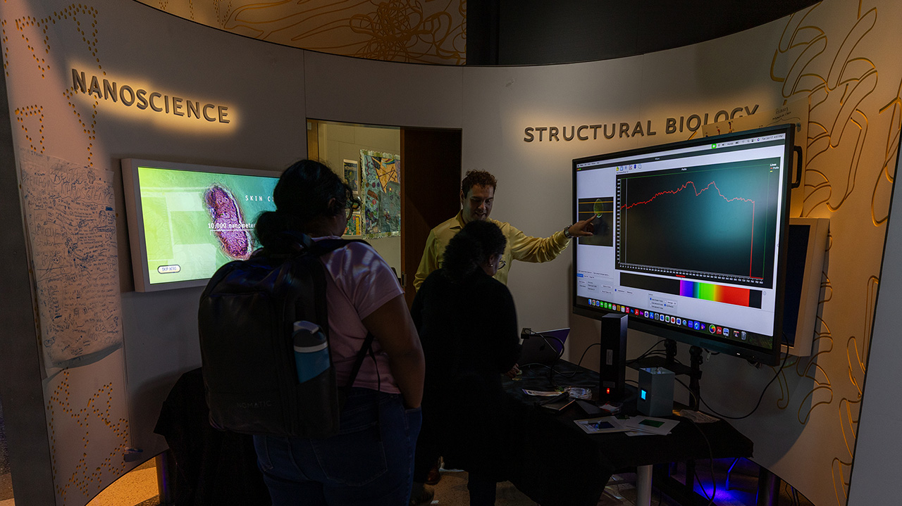 People viewing a an exhibit at the CUNY ASRC IlluminationSpace