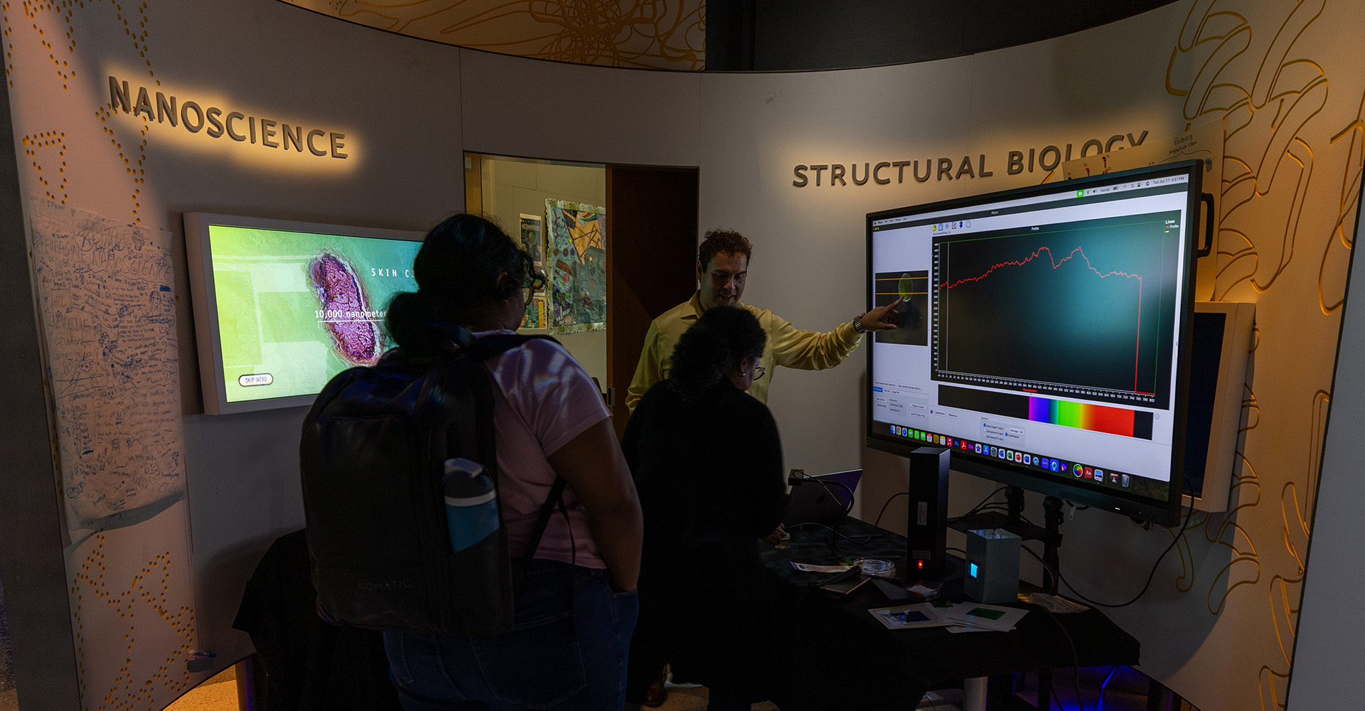 People viewing a an exhibit at the CUNY ASRC IlluminationSpace