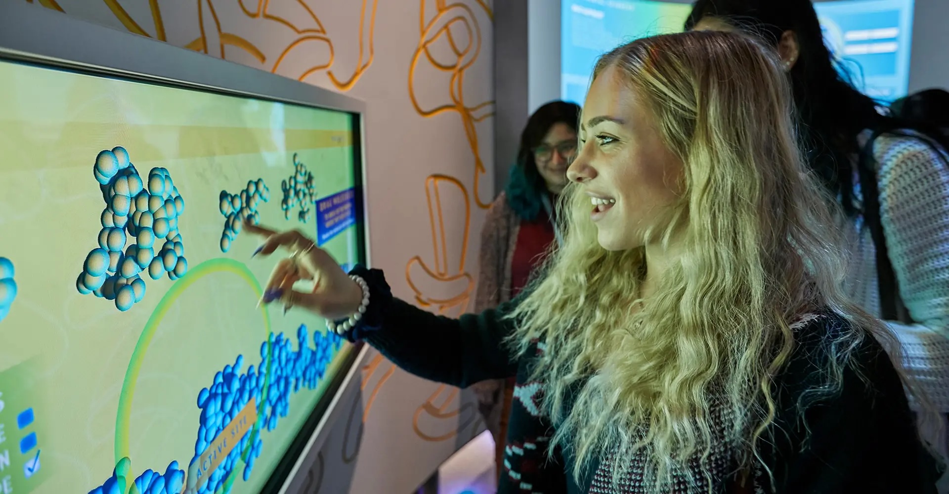 Young people interacting with an exhibit at the CUNY ASRC IlluminationSpace